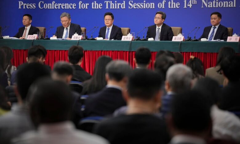 Addressing the press conference are (from left) securities regulatory chief Wu Qing, Commerce Minister Wang Wentao, NDRC chair Zheng Shanjie, Finance Minister Lan Foan and central bank governor Pan Gongsheng. Photo: AP