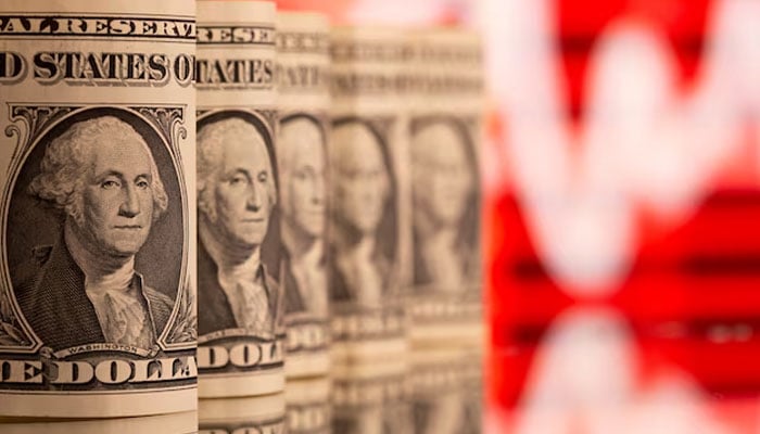US One dollar banknotes are seen in front of displayed stock graph in this illustration taken, February 8, 2021. — Reuters