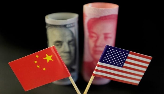 U.S. and Chinese flags are seen in front of a U.S. dollar banknote featuring American founding father Benjamin Franklin and a Chinese yuan banknote featuring late Chinese chairman Mao Zedong in this illustration picture taken May 20, 2019. — Reuters