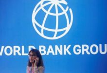 A participant stands near a logo of World Bank at the International Monetary Fund - World Bank Annual Meeting 2018 in Nusa Dua, Bali, Indonesia, October 12, 2018.— Reuters