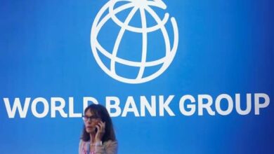 A participant stands near a logo of World Bank at the International Monetary Fund - World Bank Annual Meeting 2018 in Nusa Dua, Bali, Indonesia, October 12, 2018.— Reuters