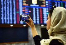 A woman takes pictures of the electronic board displaying data at the Pakistan Stock Exchange in Karachi, on December 21, 2022. — PPI