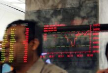 A stock trader views the performance of shares on a trading screen at PSX.— Reuters/File
