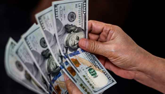 A person shows US dollars at a currency exchange store in Manila, Philippines, October 21, 2022. — Reuters
