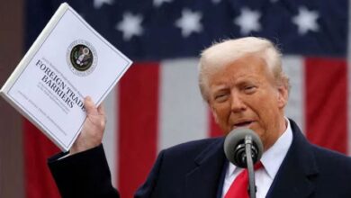 US President Donald Trump holds a Foreign Trade Barriers document as he delivers remarks on tariffs in the Rose Garden at the White House in Washington, DC, US, April 2, 2025. — Reuters