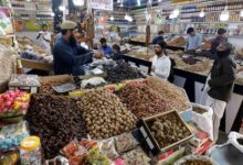 People buy dried fruits at a market in Karachi, February 1, 2023. — Reuters
