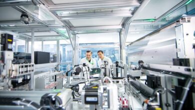 Co-CEO Dr Alex Zhavoronkov (left) and chief scientific officer Dr Feng Ren inspect equipment inside InSilico’s robotics laboratory in Suzhou, China. Photo: Handout