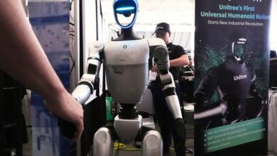 A Unitree robot shakes hands with a convention guest at the Robotics Summit & Expo, Wednesday, April 30, 2025, in Boston. (AP Photo/Charles Krupa)