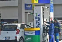 Employees at a fuel station attend to their customers in Islamabad, Pakistan. — AFP/File