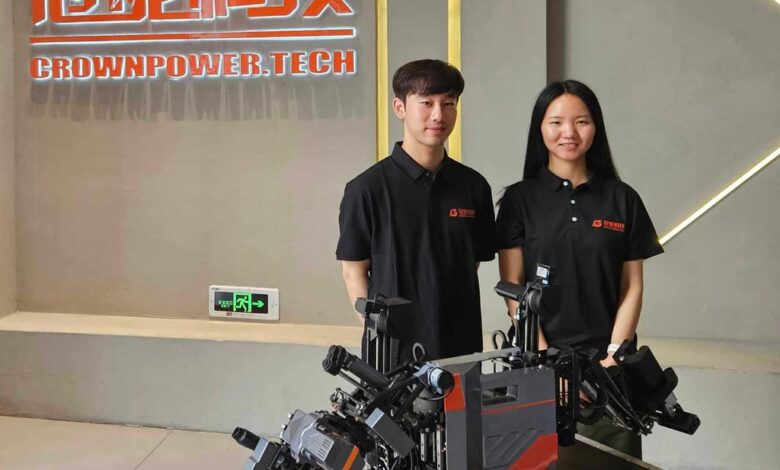 Guangdong Crownpower Electric Power Technology Development’s Jacky Yu Mingjie, left, and Aria Li Yuxin with the firm’s lead wire connection robot. Photo: Coco Feng