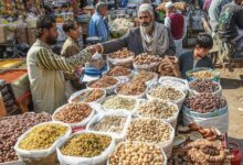 A street vendor sells dried fruits at a market in Karachi. — AFP/File