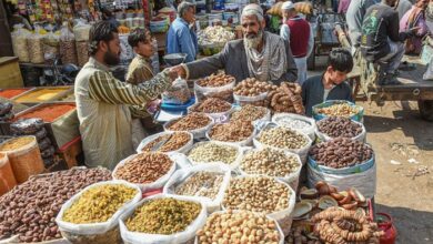 A street vendor sells dried fruits at a market in Karachi. — AFP/File