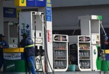 Employees at a fuel station wait for customers in Islamabad. — AFP/File