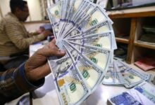 Foreign currency dealer selling US dollar bills at a money exchange company in Karachi, Pakistan on January 10, 2023. — INP