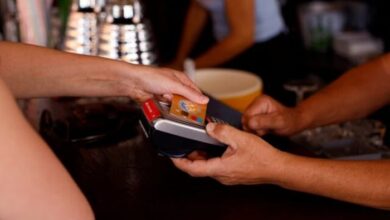 This representational image shows a woman paying with a credit card at a restaurant in Playa del Ingles, Maspalomas on the island of Gran Canaria, Spain, May 3, 2022. — Reuters