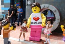 Children pose for a photo with a mascot as they visit Legoland Shanghai Resort ahead of the theme park’s opening on July 5. Photo: Reuters