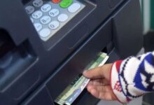 An individual withdraws money from an ATM in Islamabad. — AFP/File