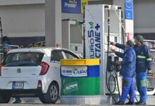 Employees at a fuel station attend to their customers in Islamabad on February 16, 2022. — AFP/File
