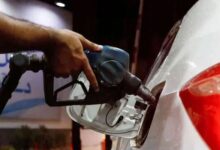A worker holds a fuel nozzle to fills fuel in a car at petrol station in Karachi, on September 16, 2023. — Reuters