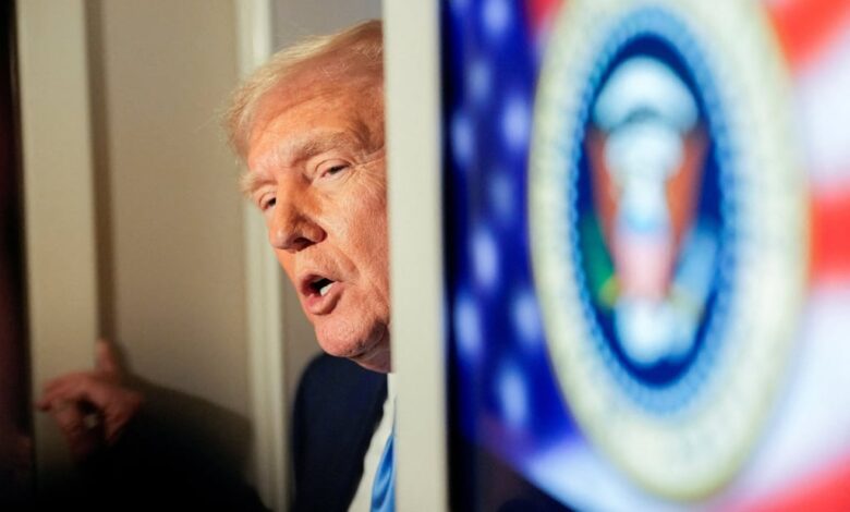 US President Donald Trump talks to members of the press aboard Air Force One. Photo: Reuters