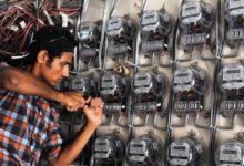 A power technician while fixing electric meters in Pakistan. — AFP/File